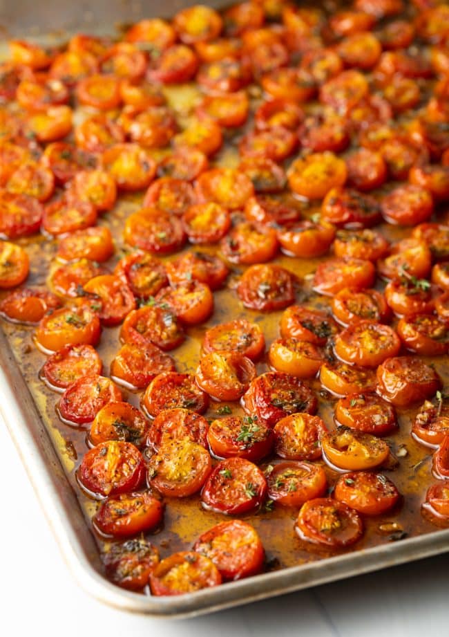 Roasted cherry tomatoes on a baking sheet. 