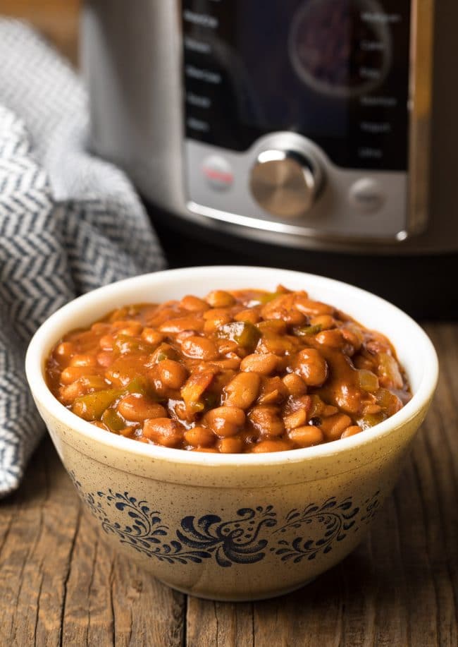 Bowl of saucy pinto baked beans on counter.