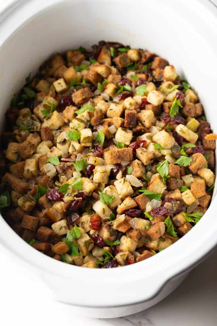 Overhead shot of crock pot stuffing recipe in a white crock pot.