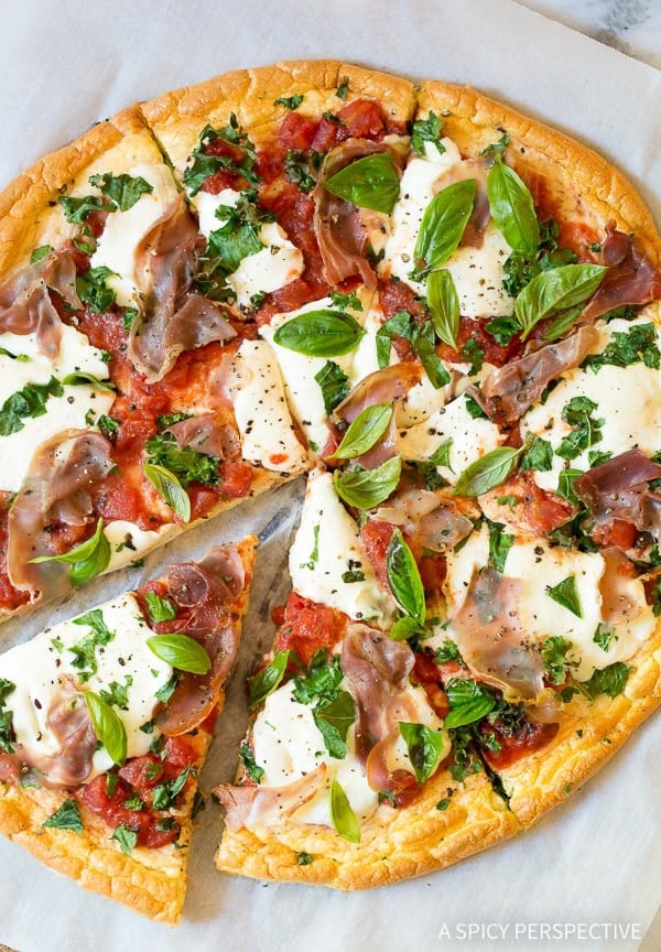 Overhead shot of low carb cloud bread pizza with mozzarella and prosciutto.