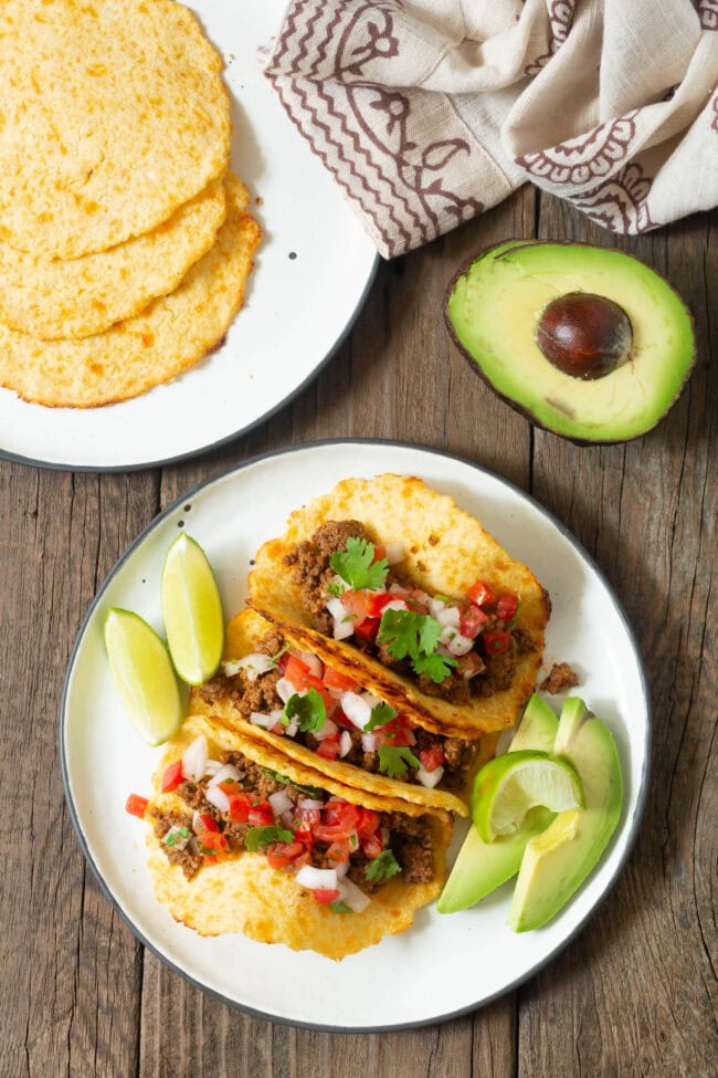 Overhead shot of three tacos on a plate made with low carb tortillas. 